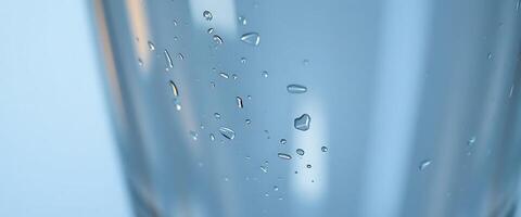 glass of water with drops of water on it photo