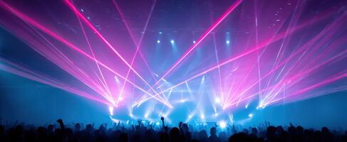 The vibrant lasers illuminate the crowd at an electrifying concert performance. photo