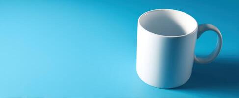 The simple white mug on a vibrant blue background for modern aesthetics. photo