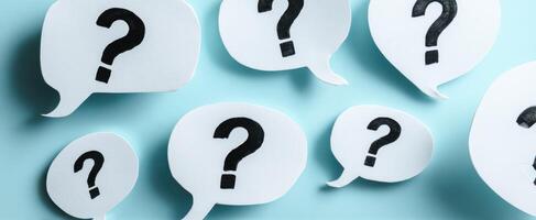 The collection of question marks in speech bubbles on a blue background. photo