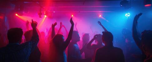 The Vibrant Atmosphere of a Nightclub Filled with Dancing People photo