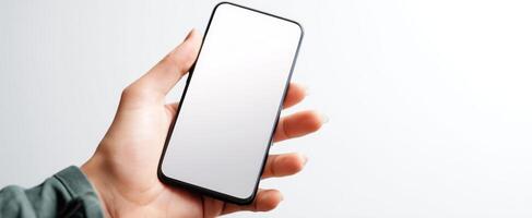 The smartphone held in a hand showcasing a blank screen for branding purposes. photo