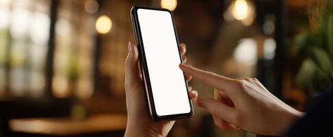 The smartphone held in a hand with a blank screen ready for interaction. photo
