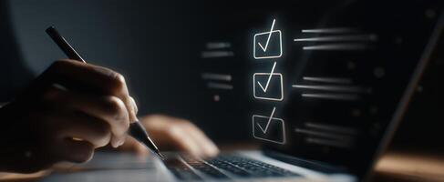 The laptop with checkmarks illuminating a modern workspace for productivity. photo