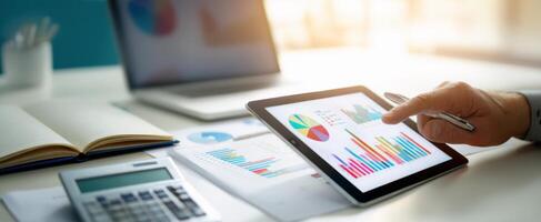 The tablet displaying colorful graphs in a modern office environment. photo