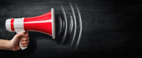 The Megaphone Representing Communication and Sound Waves on Blackboard photo