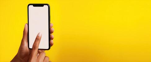 The modern smartphone being held with a finger poised to interact. photo