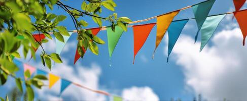The colorful flags fluttering under a bright blue sky in summer. photo