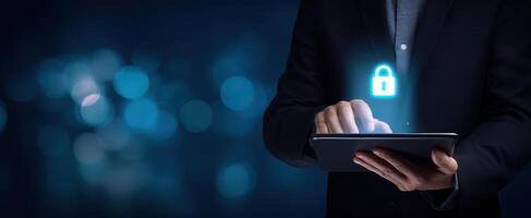 The businessman using a tablet with a glowing lock symbol for security. photo