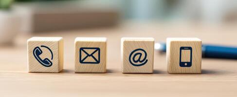 The communication symbols displayed on wooden blocks for modern business contact methods. photo