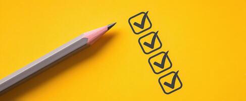 The pencil rests next to a checklist on a vibrant yellow background photo