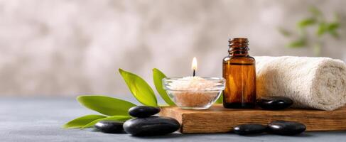 The serene spa setup with candles, stones, and essential oils for relaxation. photo