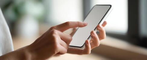 The hands of a person interacting with a modern smartphone in a cozy setting. photo