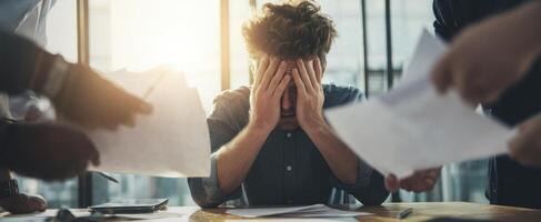 The overwhelmed employee surrounded by paperwork and stress in the office environment. photo