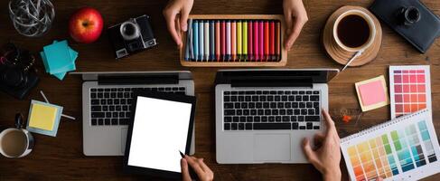 The Creative Workspace Featuring Laptops and Colorful Stationery photo