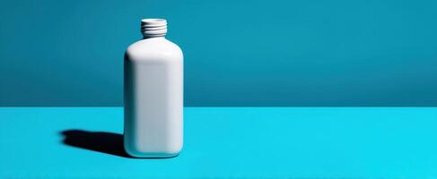 The sleek white bottle against a vibrant blue backdrop in minimalistic design. photo