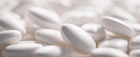 The collection of white pills in a soft-focused background. photo