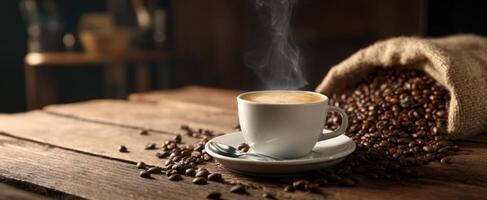 The steaming cup of coffee surrounded by freshly roasted coffee beans. photo