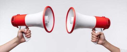 The two megaphones held by hands symbolizing communication and engagement. photo