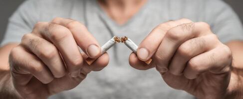 The decisive moment of breaking a cigarette to quit smoking. photo