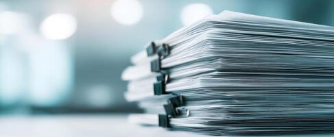 The stack of organized paperwork in a modern office setting. photo