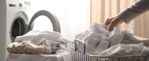 The hand sorting freshly laundered clothes in a modern laundry room. photo