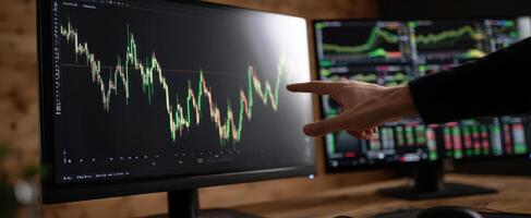 The finance professional analyzing stock market trends on computer screens. photo