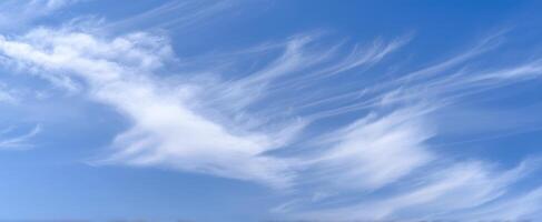 The Soft Wisps of Clouds Against a Clear Blue Sky photo