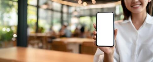 A woman holding up a blank screen on a phone photo