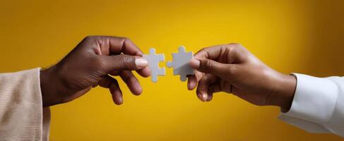 The hands connecting two puzzle pieces symbolizing collaboration and unity. photo