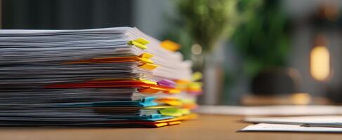 The organized stack of colorful documents on a modern office desk photo