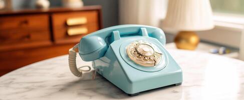 The charming blue rotary telephone on a marble table. photo