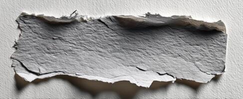 The textured appearance of torn paper on a white background for creative projects photo