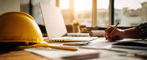 The construction worker drafting plans at a well-lit modern workspace. photo