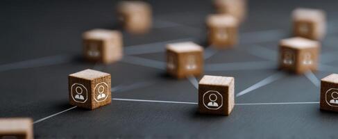 The wooden blocks representing connected individuals in a digital network themed composition. photo