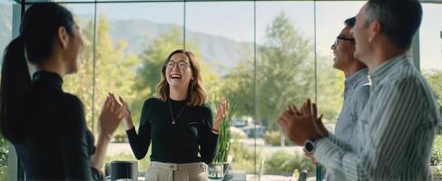 The joyful woman leading a celebration of success with her colleagues. photo