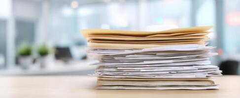 The stack of disorganized papers on an office desk in busy workspace. photo