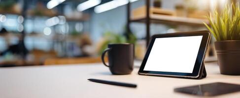 The sleek tablet and coffee cup on a modern workspace desk photo