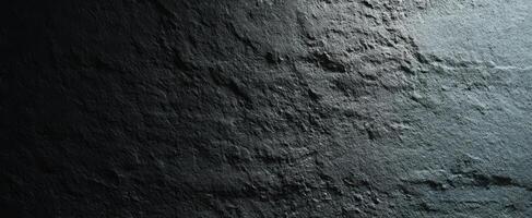 The Elegant Texture of Dark Stone Surface with Subtle Light Shadows photo