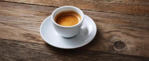 The elegant espresso cup on a rustic wooden table inviting warm moments. photo