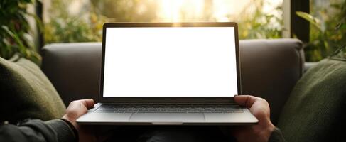 The laptop displaying a blank screen in a cozy home setting. photo