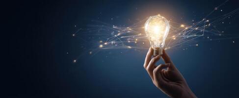 The Hand Holding a Glowing Lightbulb Representing Ideas and Innovation photo