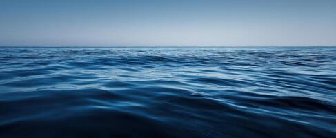 The Tranquil Surface of the Deep Blue Ocean Under a Clear Sky photo