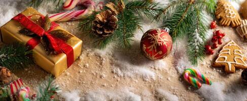 The festive arrangement of Christmas decorations and treats atop a snowy surface. photo