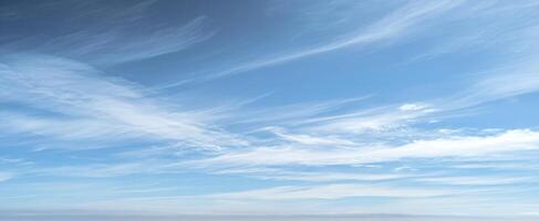 The serene sky with wispy clouds creating a tranquil atmosphere photo