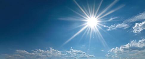 The Bright Sun Shining Over a Clear Blue Sky with Soft Clouds photo