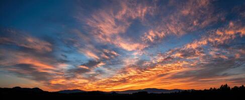 The breathtaking sunset illuminating the sky over the mountain horizon. photo