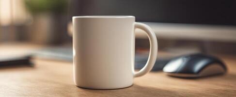 The white ceramic mug resting on a wooden desk in a modern workspace. photo