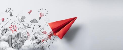 The red paper airplane soaring through a whirlwind of creativity and ideas photo