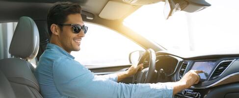 The man enjoying a drive while using the car's technology and navigating outdoors. photo